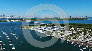 Fantastic drone view on Crandon Marina and roadbridge across water with Brickell downtown on background. Picturesque