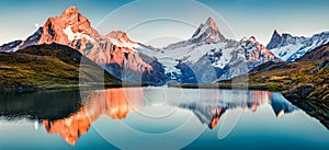 Fantastic evening panorama of Bachalp lake / Bachalpsee, Switzerland. Picturesque autumn sunset in Swiss alps, Grindelwald, Bernes