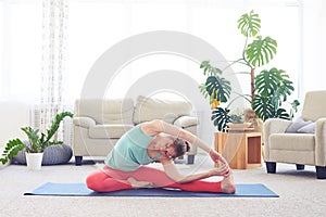 Fantastic girl stretching in revolved head-to-knee pose