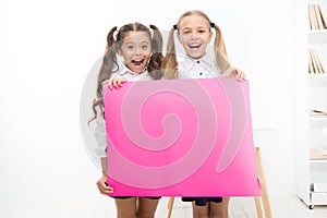 Fantastic information. Little girls holding blank paper sheet for information on white background. Small kids with blank