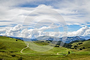 Fantastic landscape with path that climbs towards a hut seen from the Fittanze Di Sega Pass, in Lessinia, near Verona