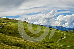 Fantastic landscape with path that climbs towards a hut seen from the Fittanze Di Sega Pass, in Lessinia, near Verona