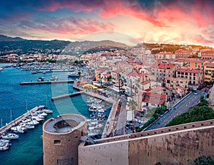 Fantastic morning cityscape of Calvi port. Aerial summer sunrise on Corsica island, France, Europe. Stunning seascape of Mediterra photo