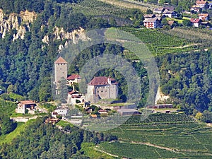 Fantastic mountain landscape. On a slope of the mountain lie at home and plantations of farms in the Southern Tyrol.