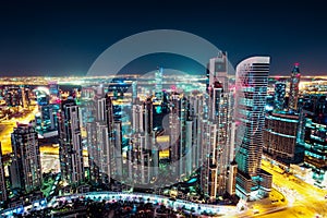 Fantastic nighttime Dubai skyline with illuminated skyscrapers.