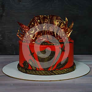 Fantastic red game of thrones cake with gilded decoration photo