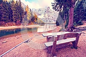 Fantastic scene with snow-covered tables and benches near the river on Fanes-Sennes-Braies natural park. Dolomites, Alps, South