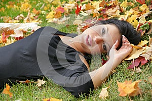Fantastic shot of sensual woman on the leafs duvet