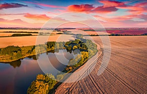 Fantastic summer sunset on outskirts of Ternopil town with small pond.