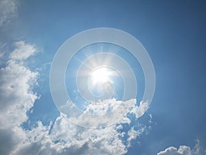 Fantastic sun and white clouds on the blue sky photo