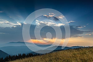 Fantastic sunrise above peaks of smoky mountain with the view into misty valley.