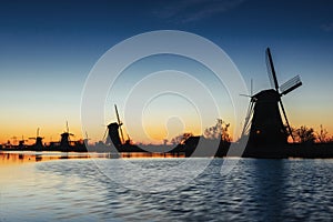 Fantastic sunset traditional Dutch windmills canal in Rotterdam.