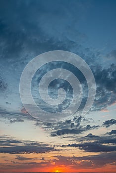 Fantastic thunderclouds at sunrise, vertical panorama