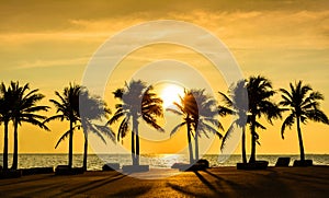 Fantastic tropical beach with palms at sunset