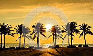 Fantastic tropical beach with palms at sunset photo