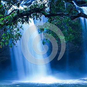 Fantastic tropical waterfall under the moonlight, gently water falling on the cliff, as a watercolor painting. Khao Yai, Thailand