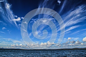 Fantastic vague white clouds against a dark blue sky float