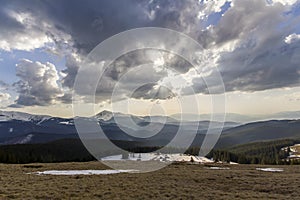 Fantastic view of huge white dark foreboding stormy cloud covering blue sky low over mountains Hoverla and Petros in Carpathian m