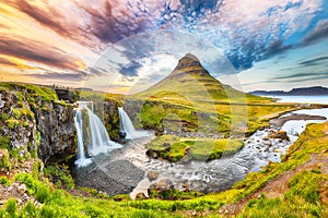 Fantastic view on Kirkjufellsfoss waterfall  near Kirkjufell mountain at sunset