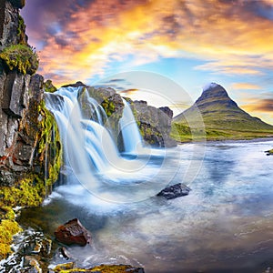 Fantastic view on Kirkjufellsfoss waterfall  near Kirkjufell mountain at sunset