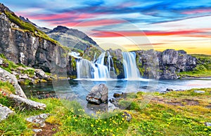 Fantastic view on Kirkjufellsfoss waterfall  near Kirkjufell mountain at sunset