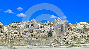 Fantastic View to the GÃ¶reme with rock houses in front of the spectacularly coloured valleys nearby,
