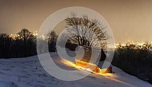 Fantastic winter landscape with glowing wooden house