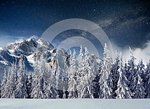 Fantastic winter meteor shower and the snow-capped mountains. Carpathians. Ukraine, Europe