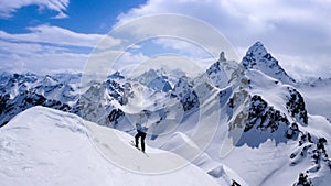 Fantastic winter mountain landscape with a male back country skier in the foreground