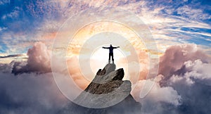 Fantasy Adventure Composite with a Man on top of a Mountain Cliff with Dramatic Cloudscape