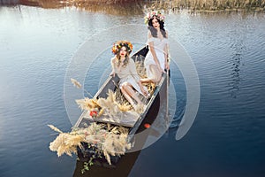 Fantasy art photo of a beautiful girls lying in boat