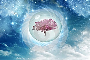 Fantasy cosmic nature with pink tree in crystal ball surrounded with stars and blue nebula