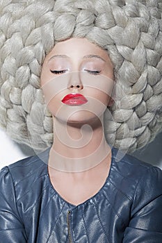 Fantasy. Creativity. Portrait of Trendy Woman in Futuristic Sumptuous Huge Wig with Braids photo
