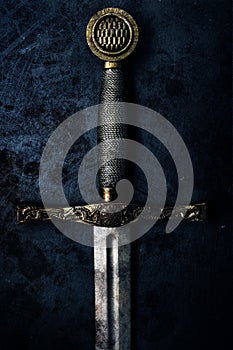 Fantasy dark sword over grunge blue background
