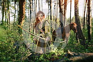 Fantasy medieval woman hunting in mystery forest