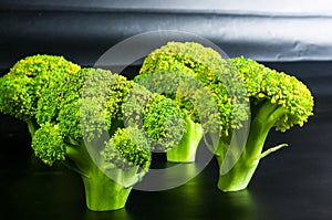 Fantasy mini landscape - trees made with broccoli on a black background, simulating a miniature forest. Concept nature