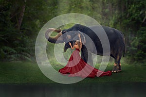 Fantasy portrait of woman with elephant in tropical forest