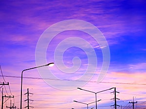 Fantasy sky background with pink clouds and highlight of streetlight after sunset