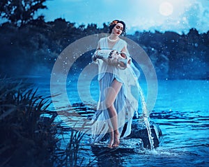 Fantasy woman Greek goddess zodiac sign Aquarius holds vintage earthenware jug in her hands and pours water into river