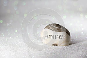 fantasy word carved on stone on white sand with glittering