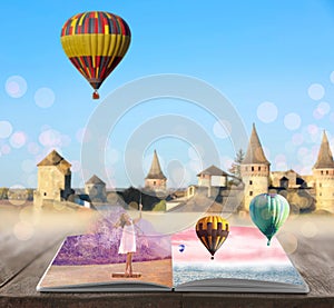 Fantasy worlds in fairytales. Book, hot air balloons and enchanted castle on background