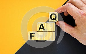 FAQ, frequently asked questions symbol. Concept word `FAQ, frequently asked questions` on cubes on a beautiful yellow background