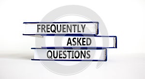 FAQ frequently asked questions symbol. Concept words FAQ frequently asked questions on books on a beautiful white table, white photo
