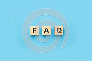 FAQ frequently asked questions text on wooden cubes. blue background. information, problem and solution concepts. FAQ abbreviation