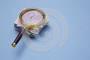 FAQ, Q and A and SEO idea. Question and answer concept. Magnifying glass and sticky note