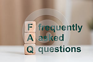 FAQ text (frequently asked questions), Text FAQ on wooden cube. Asking questions about various communication problems