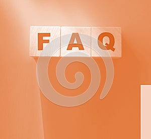FAQ text on wooden cubes on red. Frequently Asked Questions. Business concept