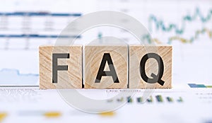 FAQ the word on wooden cubes in the background is a business diagram. Business and finance concept