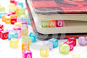 FAQ word written on colorful block