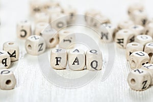 Faq word written on wood block.